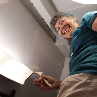 Women looking down with a paint brush in her hand