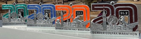 a row of Denver Colfax Marathon trophies on a shelf