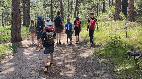 kids hiking on a trail